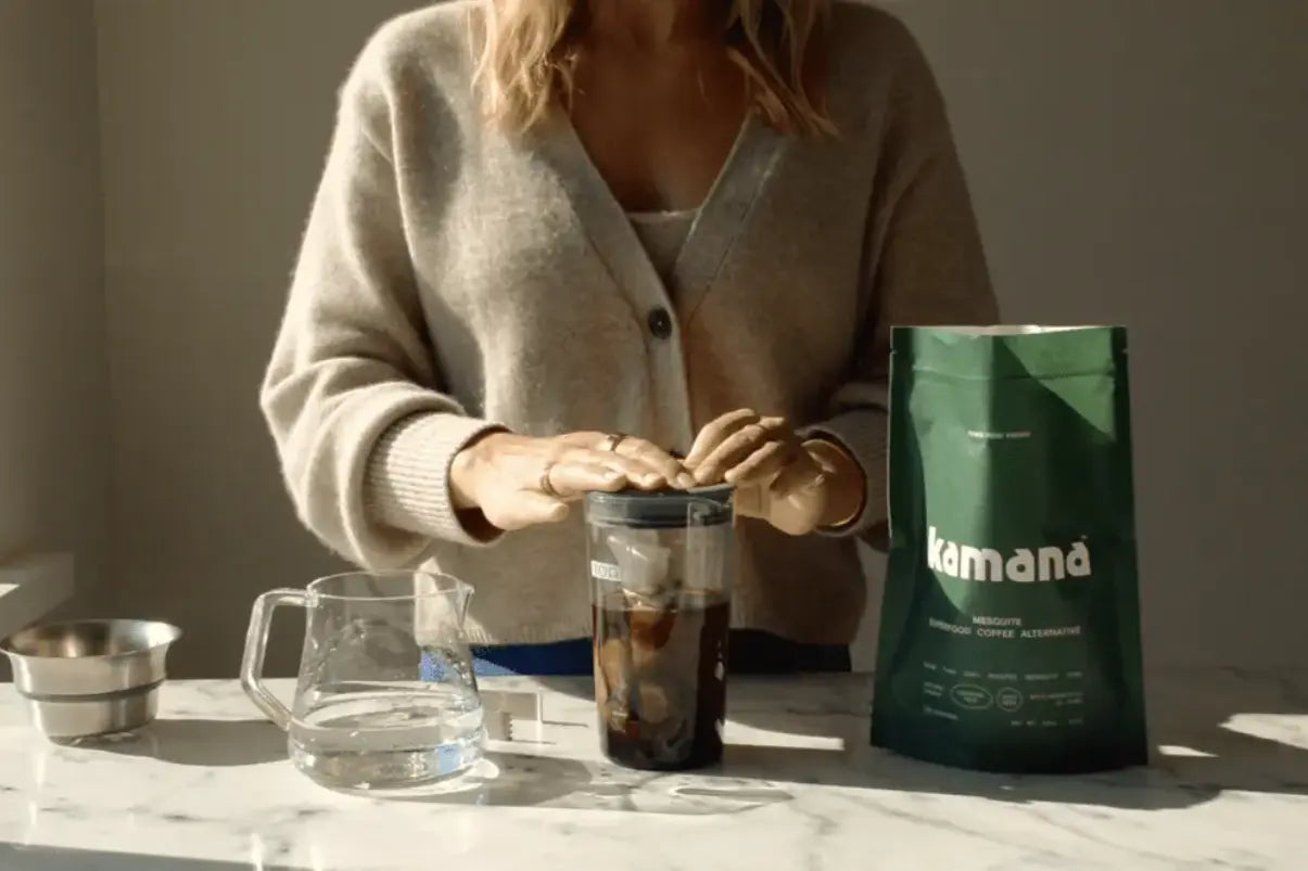 Best coffee replacement being prepared in a cold brew maker, with Kamana mesquite coffee alternative on a marble countertop