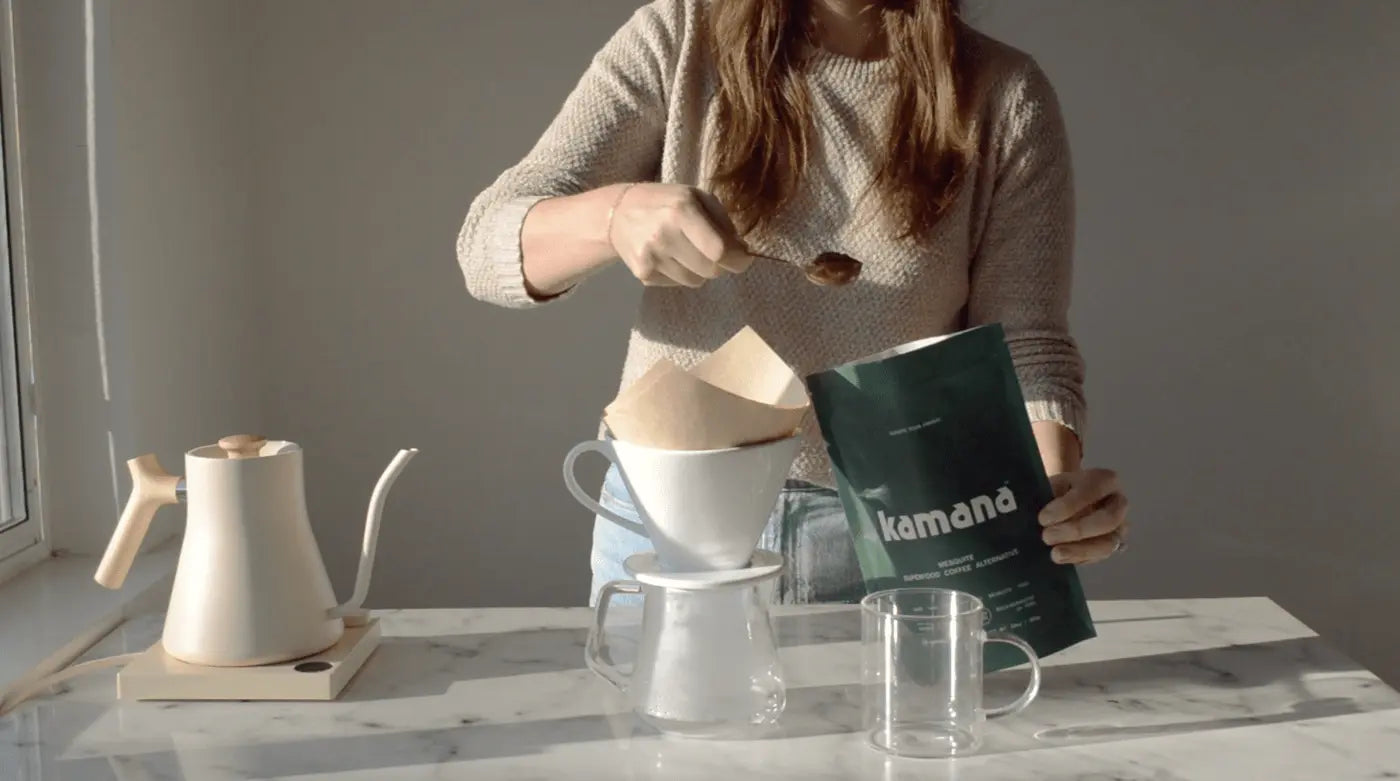 Healthy coffee alternatives being prepared using a pour-over method with a paper filter, glass carafe, and white kettle.