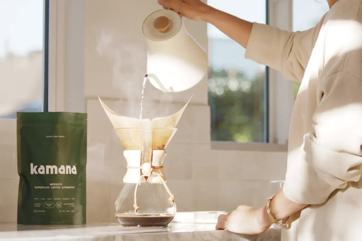 Mesquite coffee drink being brewed in a Chemex with hot water poured from a gooseneck kettle